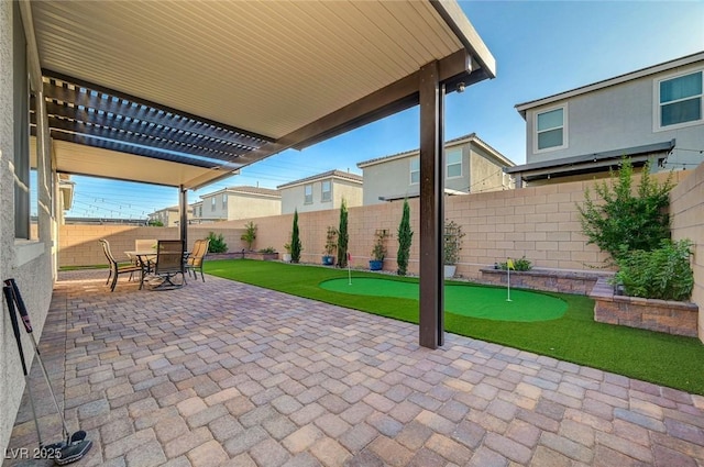 10251 Tiger Milkweed St, Las Vegas, NV 89141 - fenced backyard featuring an area to practice putting, a pergola, a patio area, and outdoor dining area