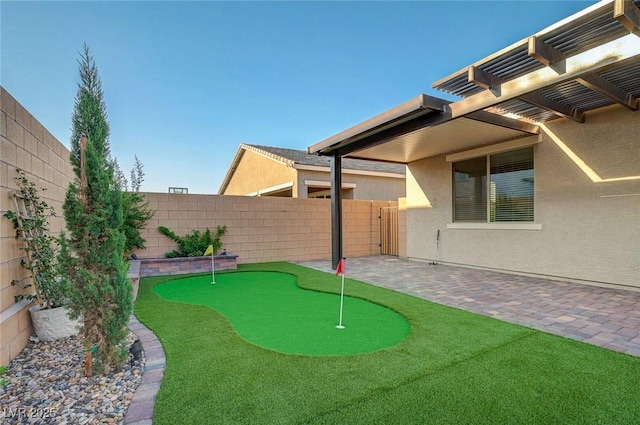 10251 Tiger Milkweed St, Las Vegas, NV 89141 - fenced backyard with a putting green, a pergola, and a patio