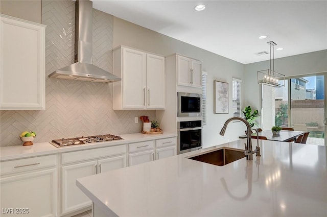 10251 Tiger Milkweed St, Las Vegas, NV 89141 - kitchen featuring wall chimney exhaust hood, stainless steel appliances, backsplash, and recessed lighting