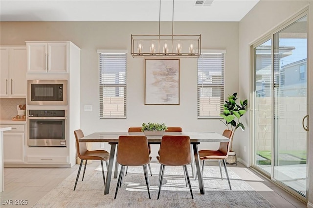 10251 Tiger Milkweed St, Las Vegas, NV 89141 - dining area with a chandelier, plenty of natural light, and light tile patterned flooring