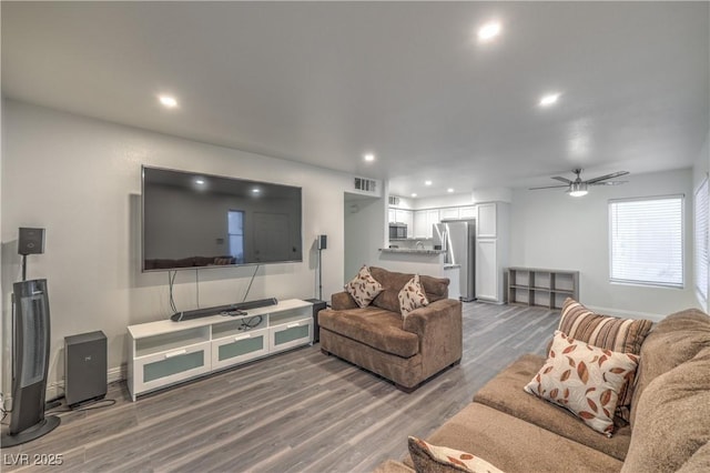 living area featuring a ceiling fan, baseboards, recessed lighting, wood finished floors, and visible vents