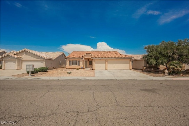 view of front of home with a garage, stucco siding, concrete driveway, and a tiled roof