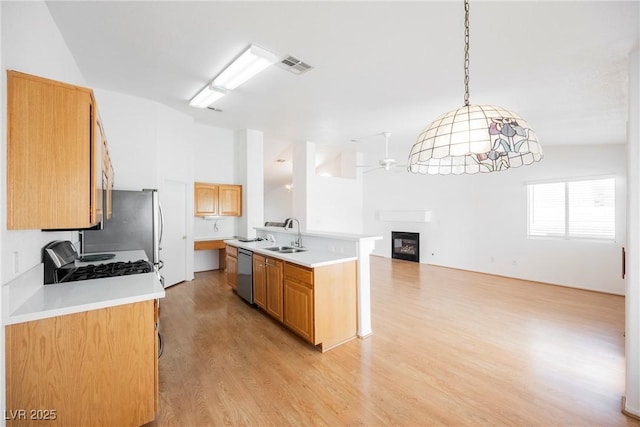 kitchen featuring ceiling fan, visible vents, stainless steel dishwasher, open floor plan, and a glass covered fireplace