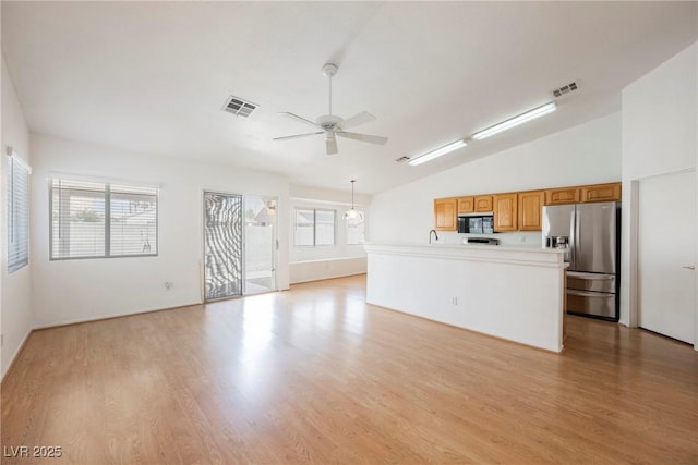 unfurnished living room featuring visible vents, light wood-style flooring, ceiling fan, and lofted ceiling