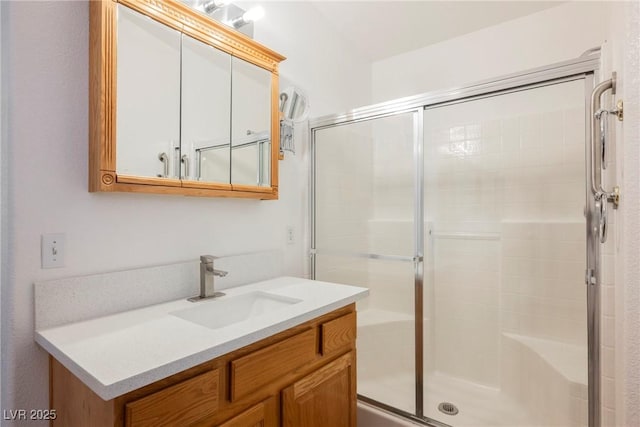 full bathroom with vanity and a shower stall