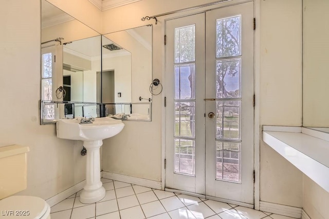 1034 Tam O Shanter, Las Vegas, NV 89109 - half bath featuring crown molding, baseboards, tile patterned floors, french doors, and toilet
