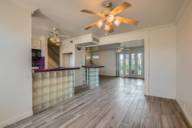 1034 Tam O Shanter, Las Vegas, NV 89109 - kitchen featuring tile countertops, black microwave, wood finished floors, ornamental molding, and ceiling fan