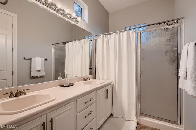 full bathroom featuring double vanity, a sink, and a shower stall