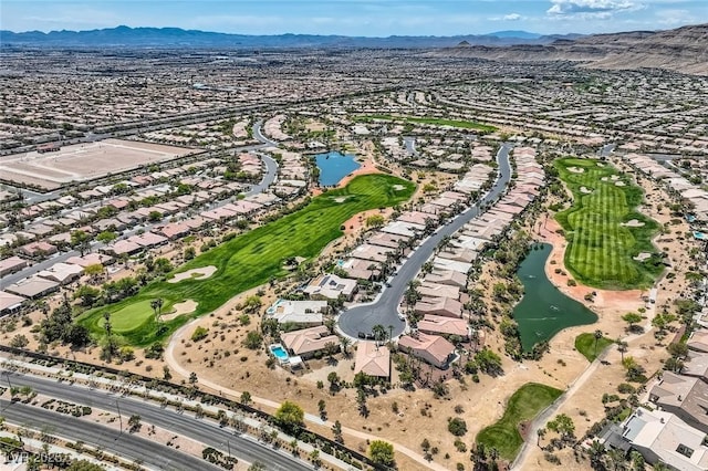 birds eye view of property with view of golf course, a residential view, and a water and mountain view