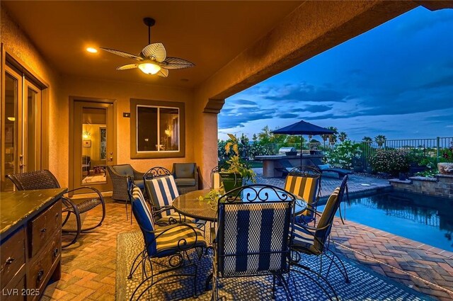 view of patio featuring a fenced in pool, a ceiling fan, fence, and outdoor dining space