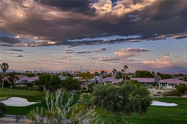 surrounding community with a residential view, a lawn, and golf course view