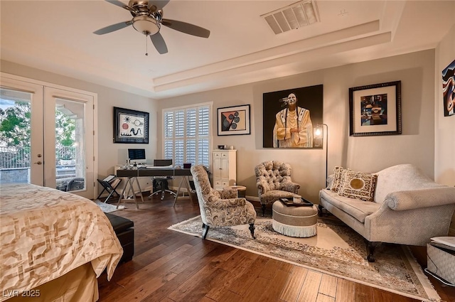 bedroom featuring access to outside, multiple windows, french doors, a tray ceiling, and visible vents