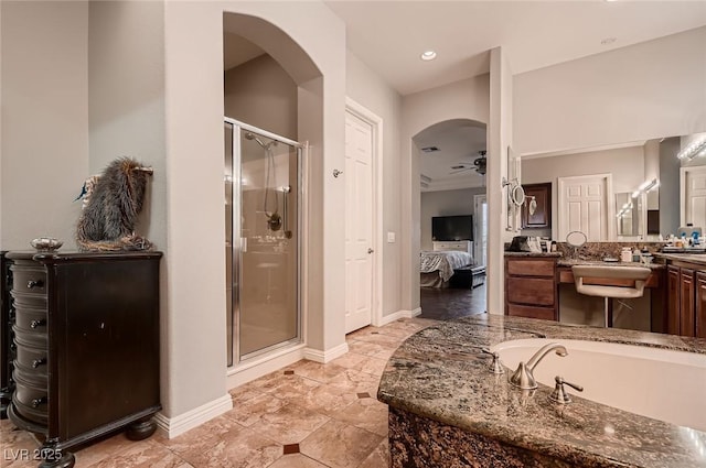full bathroom featuring ceiling fan, a bath, a shower stall, vanity, and connected bathroom