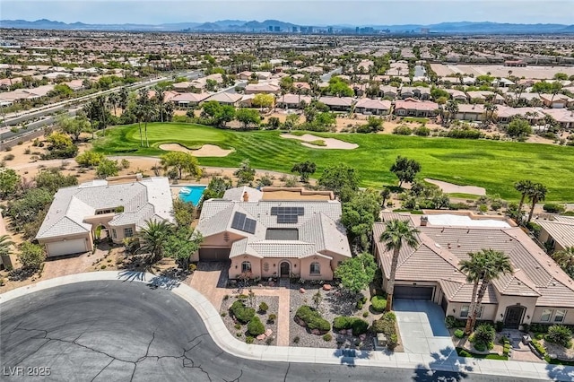 aerial view featuring view of golf course, a residential view, and a mountain view