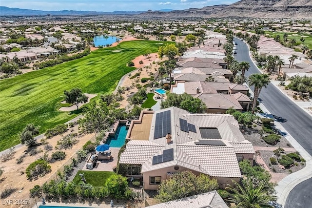 aerial view featuring a water and mountain view, view of golf course, and a residential view