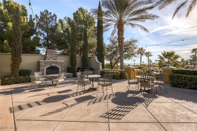 view of patio featuring an outdoor stone fireplace