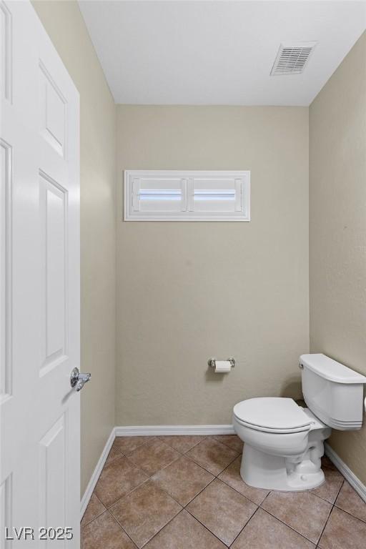 bathroom with visible vents, baseboards, tile patterned floors, and toilet