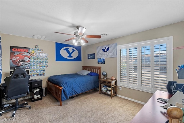bedroom with carpet floors, ceiling fan, visible vents, and baseboards