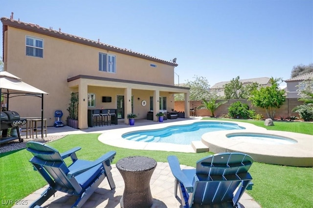 view of pool featuring outdoor dry bar, an in ground hot tub, and a patio area