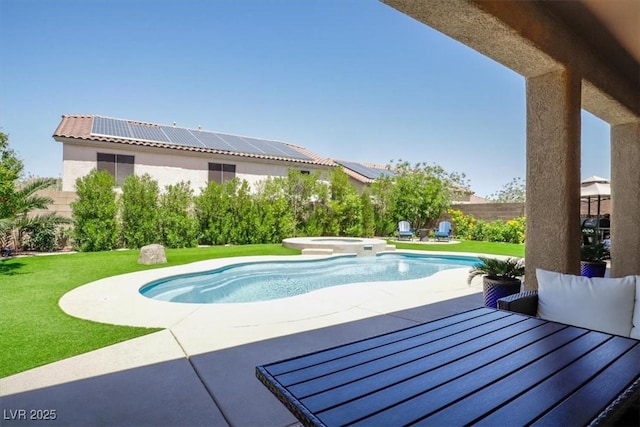 view of swimming pool with a patio, fence, a yard, and a pool with connected hot tub