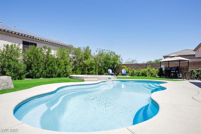 view of swimming pool featuring a gazebo, a fenced backyard, a fenced in pool, a patio area, and a yard