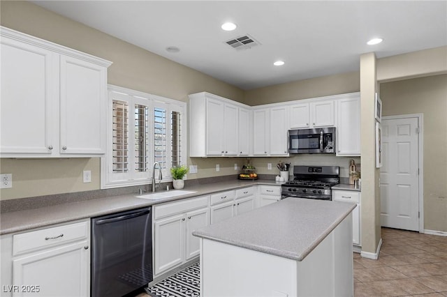 kitchen with white cabinets, appliances with stainless steel finishes, a sink, and visible vents