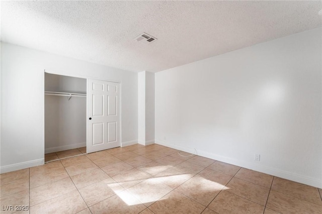 3151 Soaring Gulls Dr Unit 1168, Las Vegas, NV 89128 - unfurnished bedroom featuring light tile patterned flooring, a textured ceiling, baseboards, visible vents, and a closet