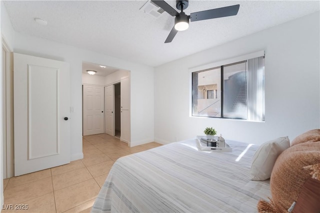 3151 Soaring Gulls Dr Unit 1168, Las Vegas, NV 89128 - bedroom with baseboards, ceiling fan, light tile patterned flooring, and visible vents