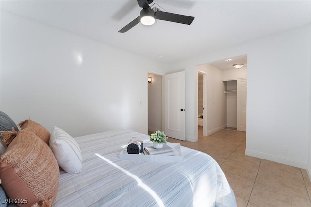 3151 Soaring Gulls Dr Unit 1168, Las Vegas, NV 89128 - bedroom featuring ceiling fan, light tile patterned floors, baseboards, a closet, and a spacious closet