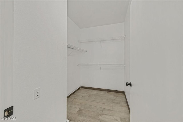 walk in closet featuring light wood-style flooring