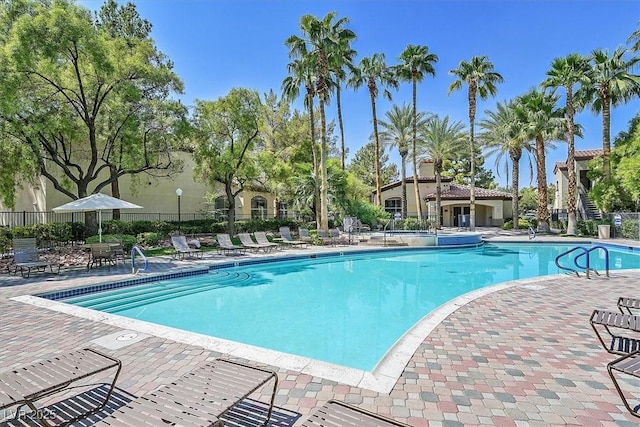 pool with fence and a patio