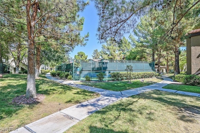 view of property's community featuring fence and a yard