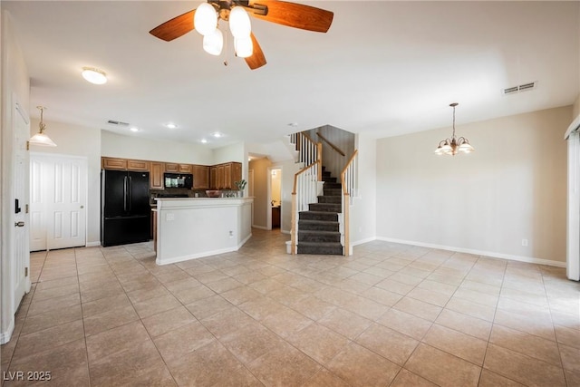 kitchen featuring open floor plan, ceiling fan with notable chandelier, light tile patterned floors, and black appliances