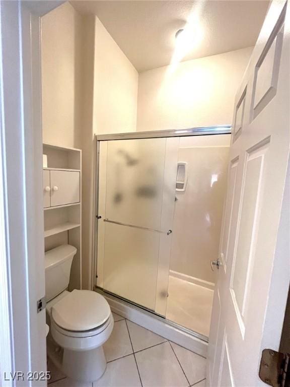 2925 Big Green Ln, Las Vegas, NV 89134 - bathroom with tile patterned floors, toilet, and a stall shower