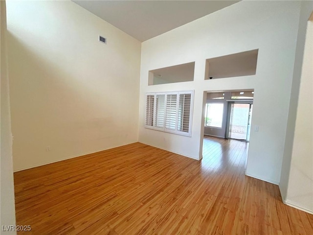 2925 Big Green Ln, Las Vegas, NV 89134 - unfurnished room with light wood-type flooring, a towering ceiling, and baseboards