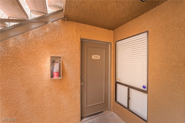view of exterior entry with stucco siding