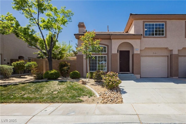 1617 Cave Spring Dr, Henderson, NV 89014 - view of front of home with fence, an attached garage, stucco siding, a chimney, and driveway