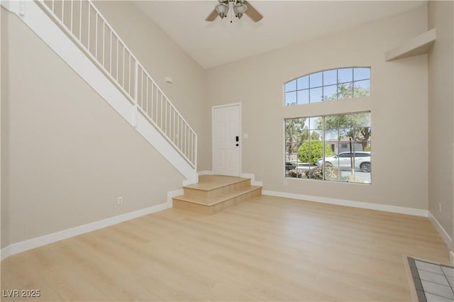 1617 Cave Spring Dr, Henderson, NV 89014 - foyer featuring a towering ceiling, wood finished floors, baseboards, ceiling fan, and stairway