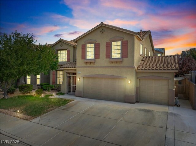 248 Hyssop Ct, Henderson, NV 89015 - mediterranean / spanish home with fence, a garage, stucco siding, a tiled roof, and driveway
