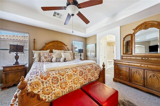 248 Hyssop Ct, Henderson, NV 89015 - bedroom with carpet floors, arched walkways, a tray ceiling, and visible vents