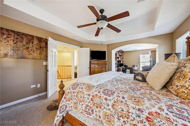 248 Hyssop Ct, Henderson, NV 89015 - bedroom with carpet flooring, ceiling fan, arched walkways, baseboards, and a tray ceiling
