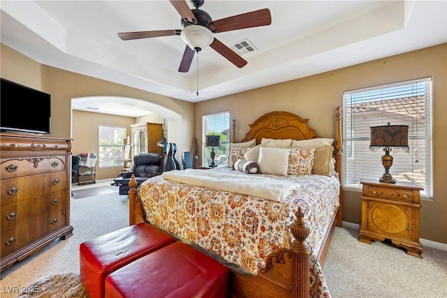 248 Hyssop Ct, Henderson, NV 89015 - carpeted bedroom with arched walkways, a ceiling fan, baseboards, a tray ceiling, and visible vents