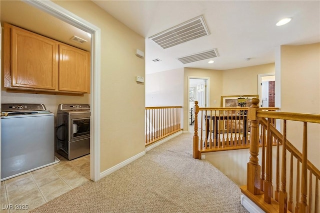 248 Hyssop Ct, Henderson, NV 89015 - hall featuring separate washer and dryer, visible vents, an upstairs landing, and light colored carpet