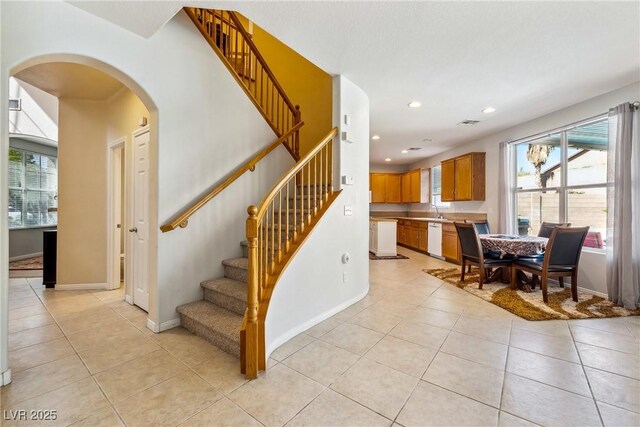 248 Hyssop Ct, Henderson, NV 89015 - stairs featuring tile patterned flooring, arched walkways, and a wealth of natural light