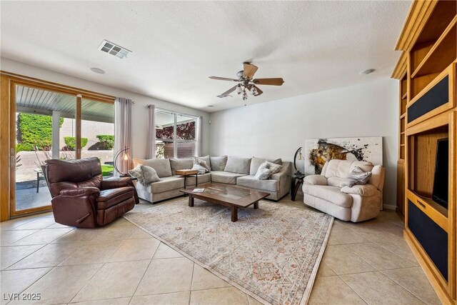 248 Hyssop Ct, Henderson, NV 89015 - living area featuring light tile patterned floors, plenty of natural light, a ceiling fan, and visible vents