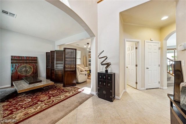 248 Hyssop Ct, Henderson, NV 89015 - hallway with arched walkways, baseboards, visible vents, and light tile patterned floors