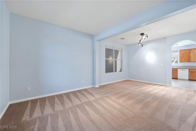 248 Hyssop Ct, Henderson, NV 89015 - unfurnished room with arched walkways, baseboards, and light carpet