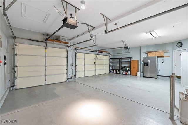 248 Hyssop Ct, Henderson, NV 89015 - garage featuring stainless steel fridge and a garage door opener