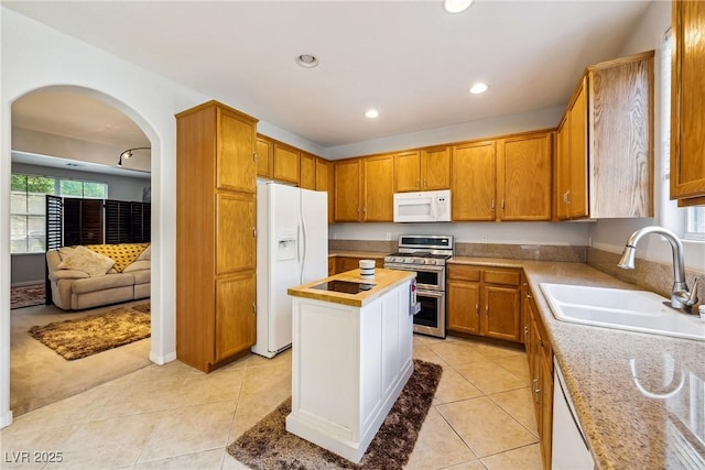 248 Hyssop Ct, Henderson, NV 89015 - kitchen with a sink, arched walkways, plenty of natural light, and white appliances