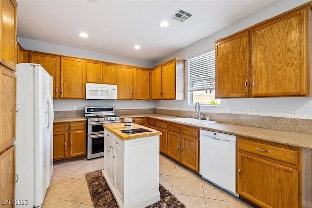 248 Hyssop Ct, Henderson, NV 89015 - kitchen featuring visible vents, brown cabinets, a sink, light tile patterned floors, and white appliances